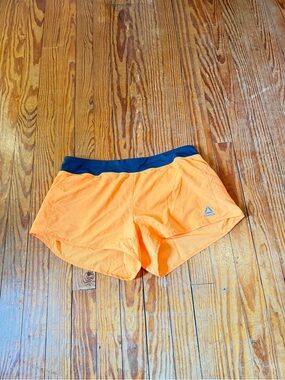 Les Mills Reebok Orange Performance Shorts with Navy Trim